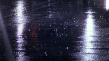 Cars driving on wet roads at night