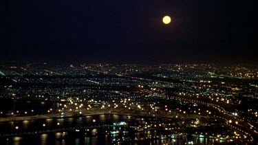 City at night with full moon