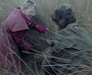 The scientists have found tagged echidna in long grass.