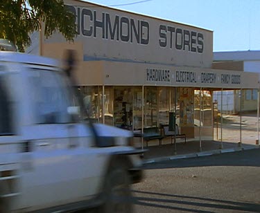 Outback town. Men driving in truck. Statue of Kronosaurus dinosaur. Richmond. Queensland. Central Australia