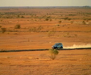 Zoom out. 4wd Four wheel-drive 4x4 driving on outback desert road.