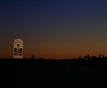 Kynuna. Night. Small outback town. Signpost for pub.