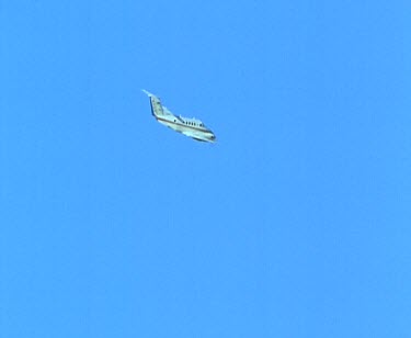 Light propeller plane in flight across blue sky. Int pilots and control panel