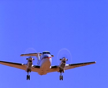 Light propeller plane in flight across blue sky. Take-off into blue sky.