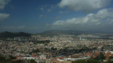 This congested part of Barcelona is treated to a beautiful day full of sunlight pearing past the timelapsed clouds.