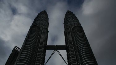 Clouds fly by the prominent Petrona Twin Towers in the city of Kuala Lumpur, Malaysia.