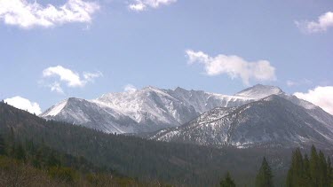 Snow-covered peaks and forested slopes
