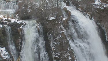 Powerful waterfall and cascades in winter