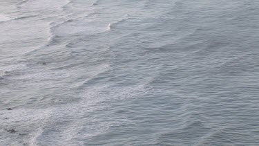 Gentle waves on pristine cove and shoreline