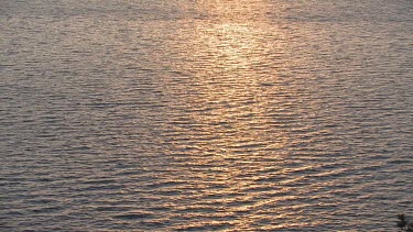 Sparkling water reflecting sunrise or sunset