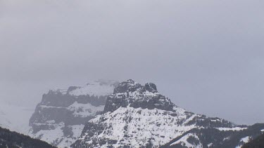 Mountains with snowy peaks and cloud cover