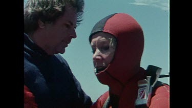 Valerie Taylor is helped out of her diving gear after a shark attack