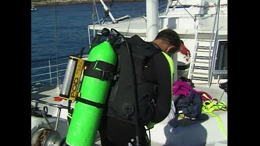 Ian Gordon attaches the Shark Pod equipment to his scuba gear enters the water to begin testing.