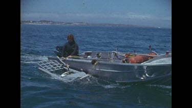 Abalone diver with equipment in motor boat