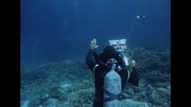 diver videoing and directing with hands