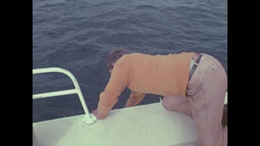 man pull top of dummy onto deck, empties out and turns over so bite hole is visible