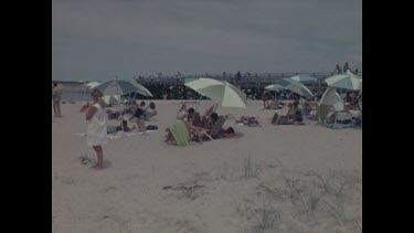 beach, people lying under beach umbrellas