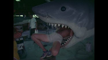 huge dummy shark, worker in mouth