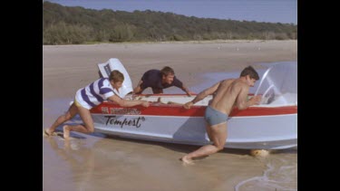 men push boat into water
