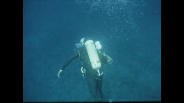 Henri diving underwater, holding camera