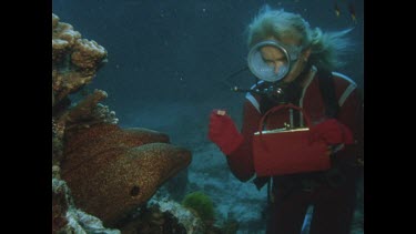 Valerie feels two Moray Eels from fish out of red handbag