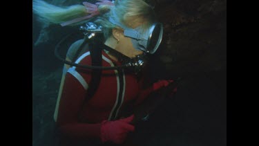 Valerie holds up mirror in front of two Moray Eels