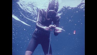 diver loading gun underwater