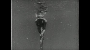 Sequence of shots. Black and white film footage. Shark Hunting with Movietone. Valerie spears a shark