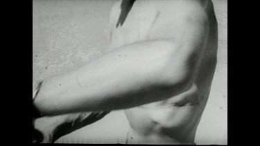 Sequence of shots. Movietone Revenge for victim of shark attack. Shark victim shows scar from bite. He prepares to hunt his attacker