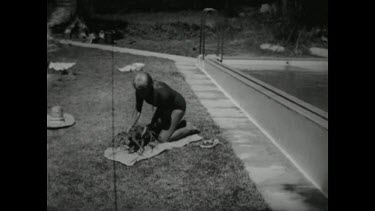 Sequence of shots. Movietone. Crayfish makes unusual pet. Placing crayfish in swimming pool and swimming with it.