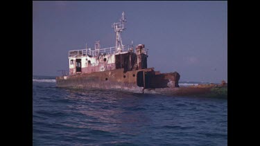 woman taking photograph of ship wreck