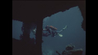 divers explore shipwreck