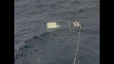 diver cage in choppy water
