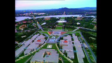 Parliament House with Lake Burley Griffin and Canberra city in background.