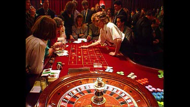 Gamblers playing roulette in casino