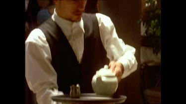 Waiter pouring tea