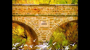 birds fly in front of sign on old bridge at Richmond, "AD 1823".