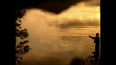 Sunset, man trout fishing