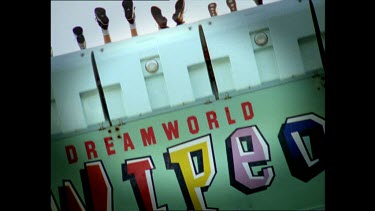 People strapped into Dreamworld "Wipeout" ride, turning upside down.