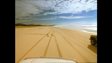 Four wheel drive driving along beach. Fraser Island