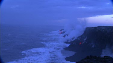 Establishing shot. Edge of lava delta beach, the waves crashing into the volcano and turning to steam. Birds flying. Incandescent lava. Sunrise. Daybreak.