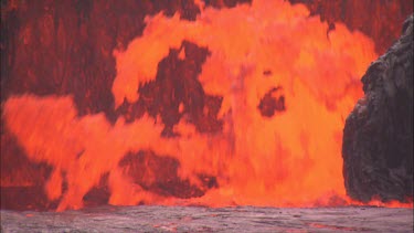 CM0080-TV-0042674 Lava erupting from vent pull back to reveal cameraman filming eruption