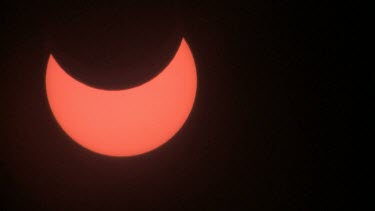 partial solar eclipse with clouds in foreground, Israel 2011