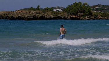 Man Runs Into Rolling Waves & Surf, Kalathas Beach, Crete, Greece, Europe