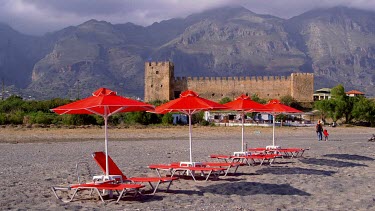 Red Sun Beds, Parasols, Castle & Mountains, Frangokastello, Crete, Greece