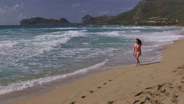 Teenage Girl On Beach In Pink Bikini, Falasarna, Crete, Greece
