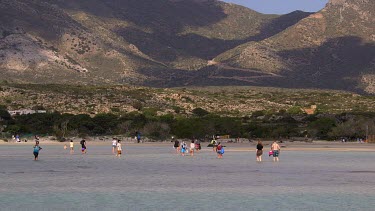 People Walking In Lagoon, Elafonisi, Crete, Greece