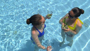 Mother & Daughter In Swimming Pool Drinking Cocktail, Elounda, Crete, Greece