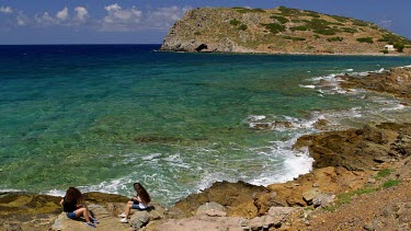 Tourists Watch Waves Crash Onto Rocks, Gulf Of Mirabello, Crete, Greece