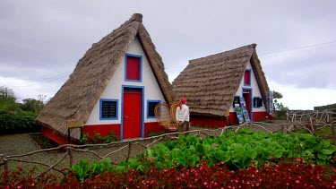 Local Lady At Traditional Thatched Triangular Houses, Santana, Madeira, Portugal